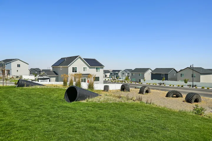 Expansive manicured lawn with mature landscaping, situated in an established residential community