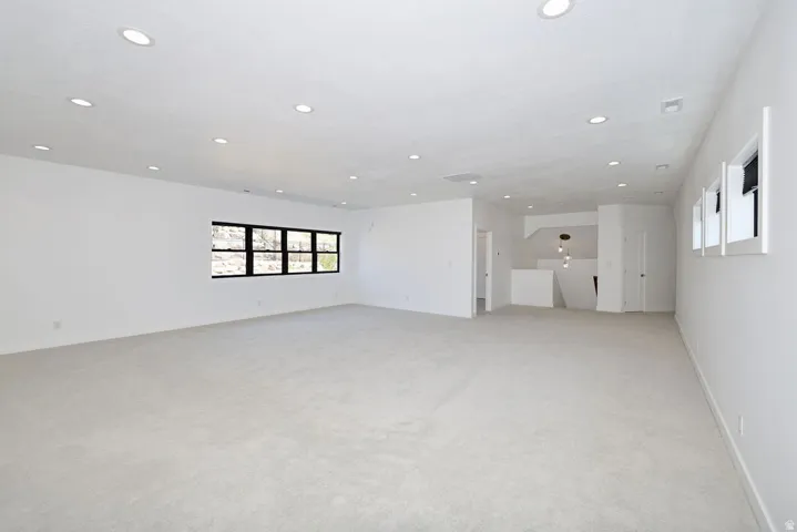 Expansive carpeted area featuring recessed lighting
