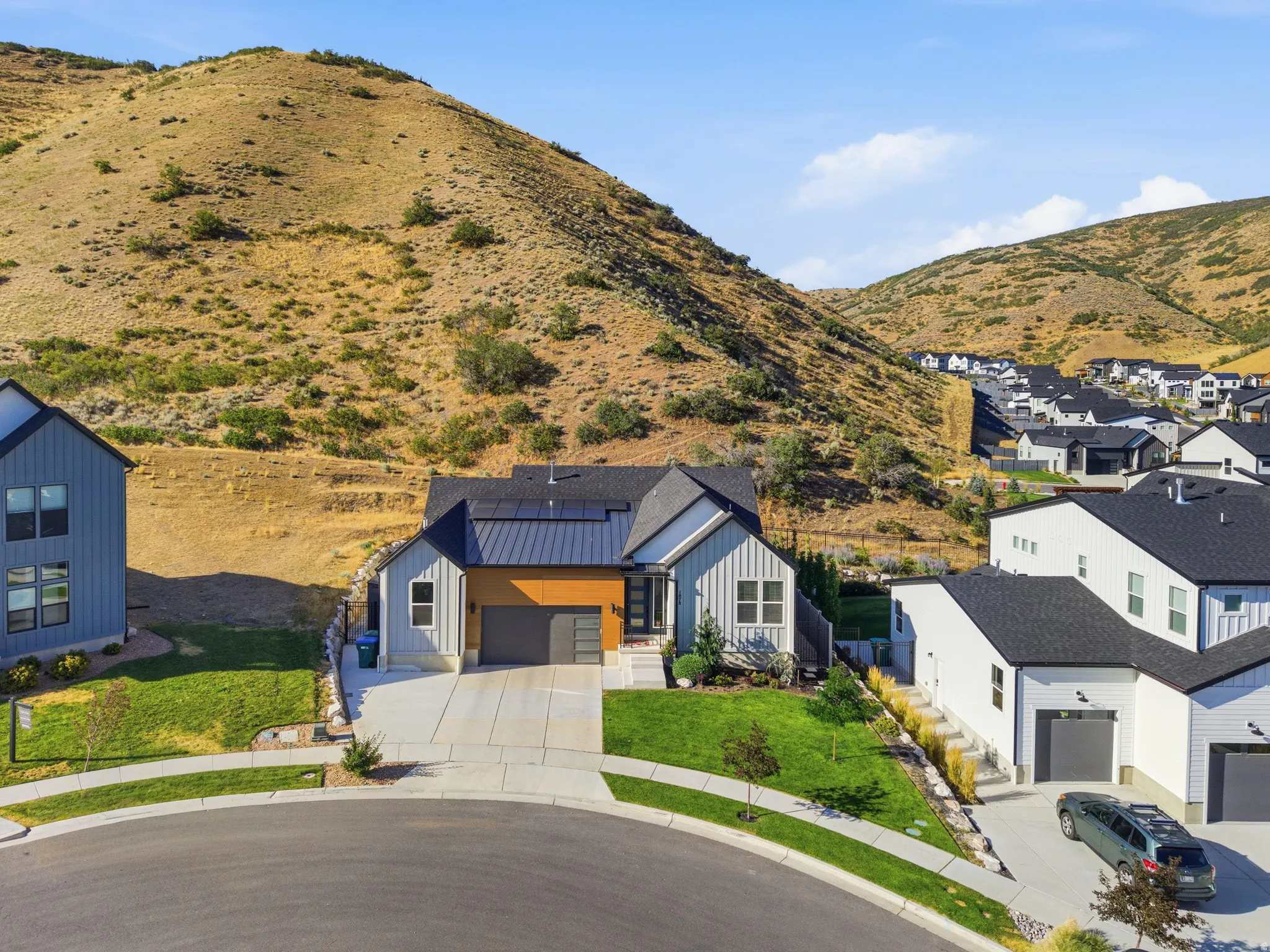 Contemporary residence featuring a blend of vertical siding and wood-finish accents