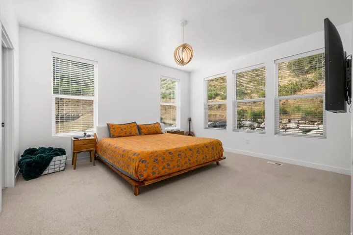 Bright bedroom with light-colored carpeting and white walls