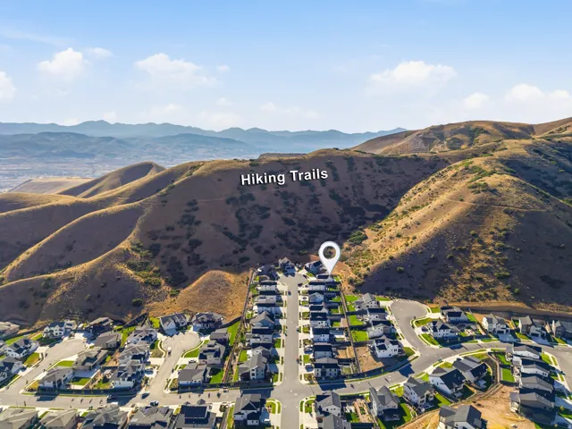 Residential community situated at the base of expansive hillsides, featuring hiking trails