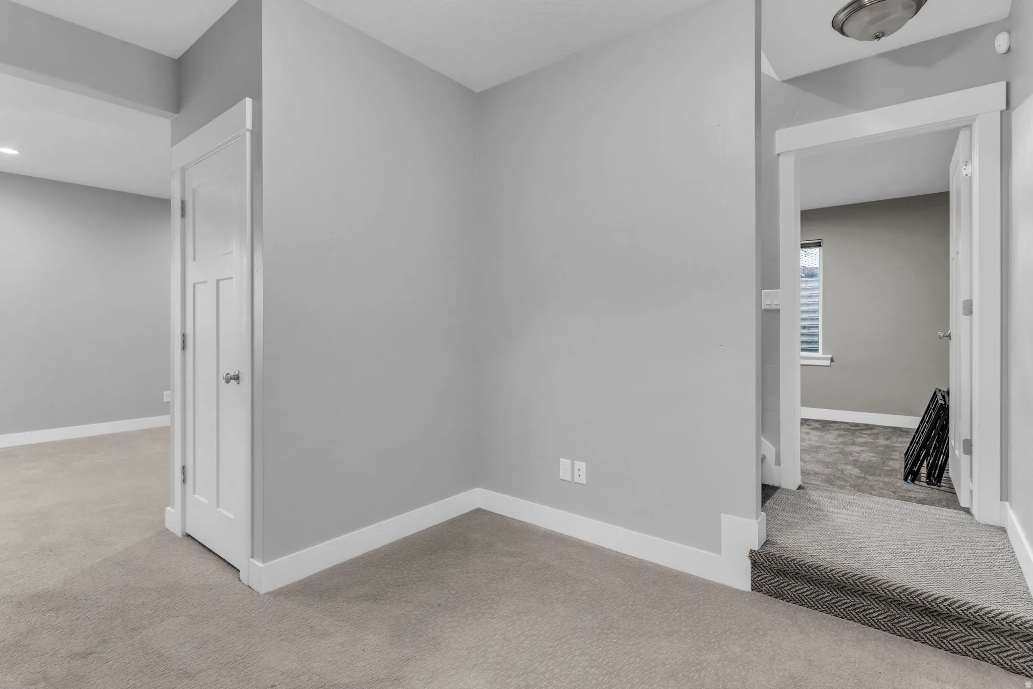Carpeted interior featuring light gray wall paint and white trim