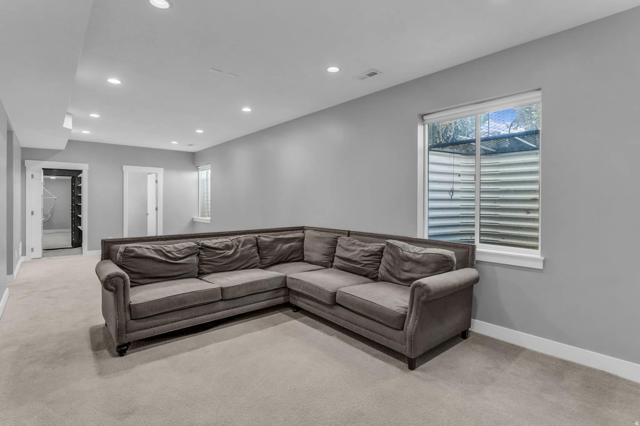 Carpeted room with recessed lighting, light gray walls, and white trim