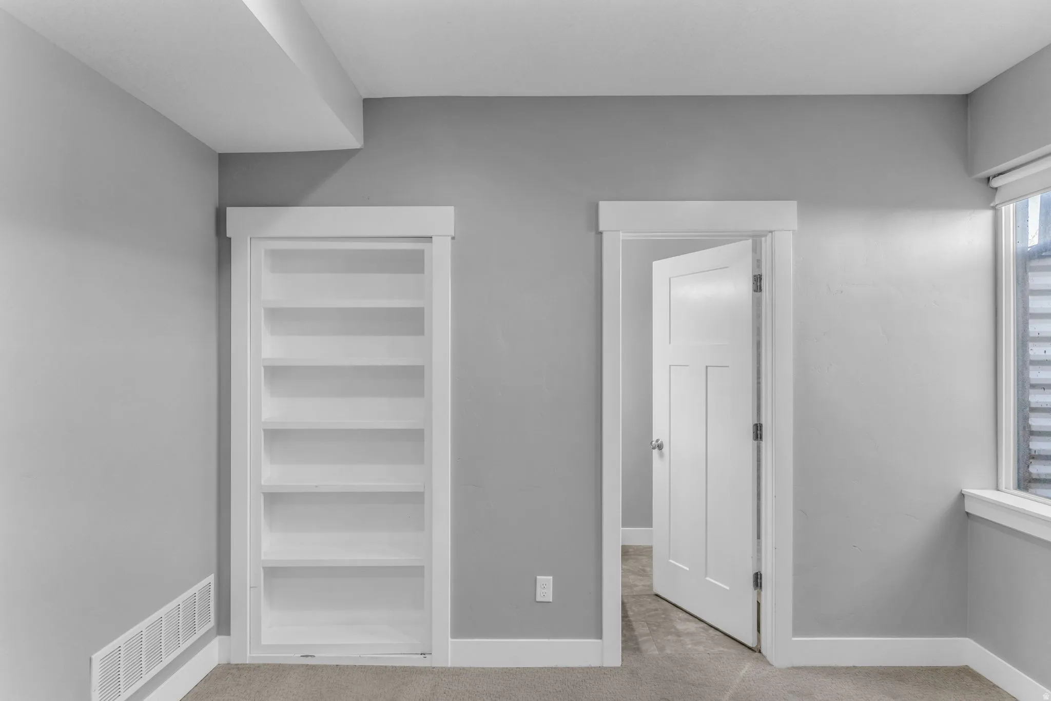 Built-in shelving unit with white trim and a neutral color palette