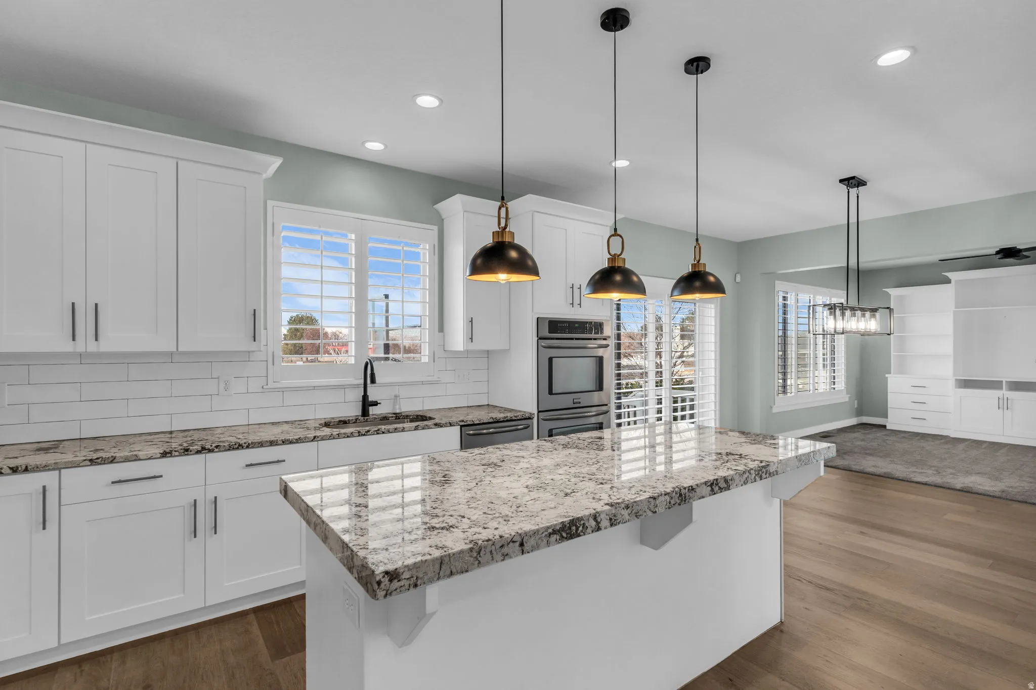 Kitchen featuring a central island with a stone countertop and pendant lighting