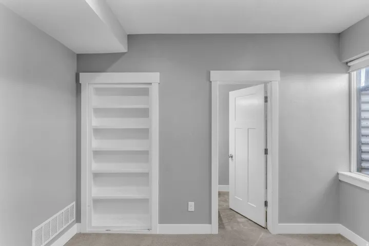 Built-in shelving unit with white trim and a neutral color palette