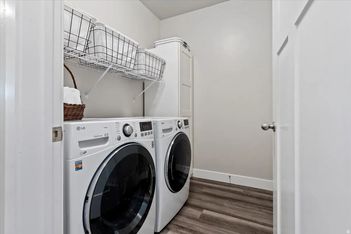 LAUNDRY - Dedicated laundry area featuring wood-finish flooring, white walls, and a white wire shelving system
