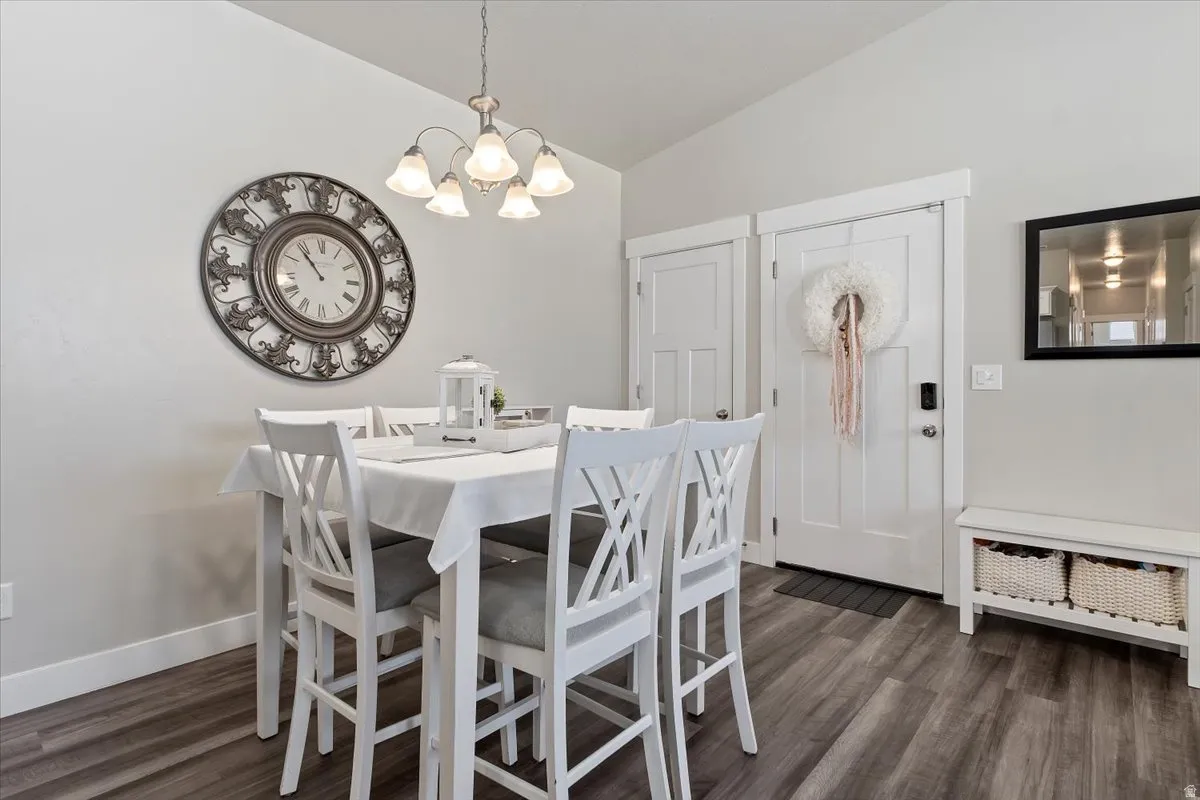 Dining area featuring wood-finish flooring and a contemporary chandelier