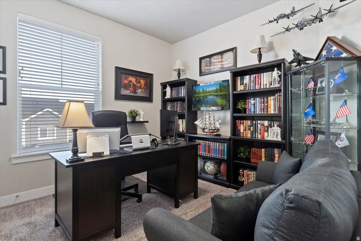 3RD BEDROOM OR OFFICE - Bright room featuring a window with horizontal blinds, neutral wall paint, and light-colored carpet flooring