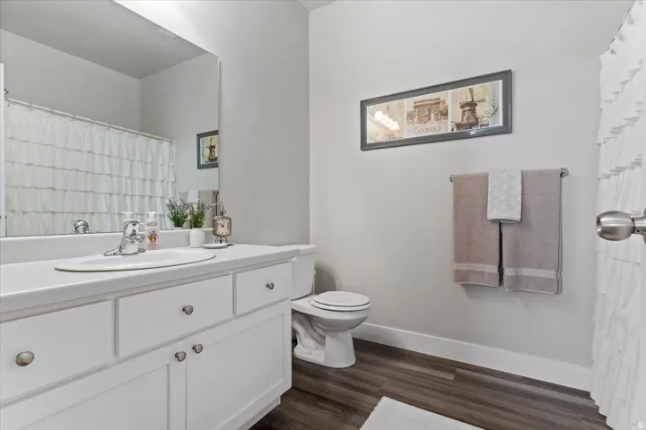 2ND BATHROOM - featuring a white vanity with integrated sink, chrome faucet, and matching white cabinetry