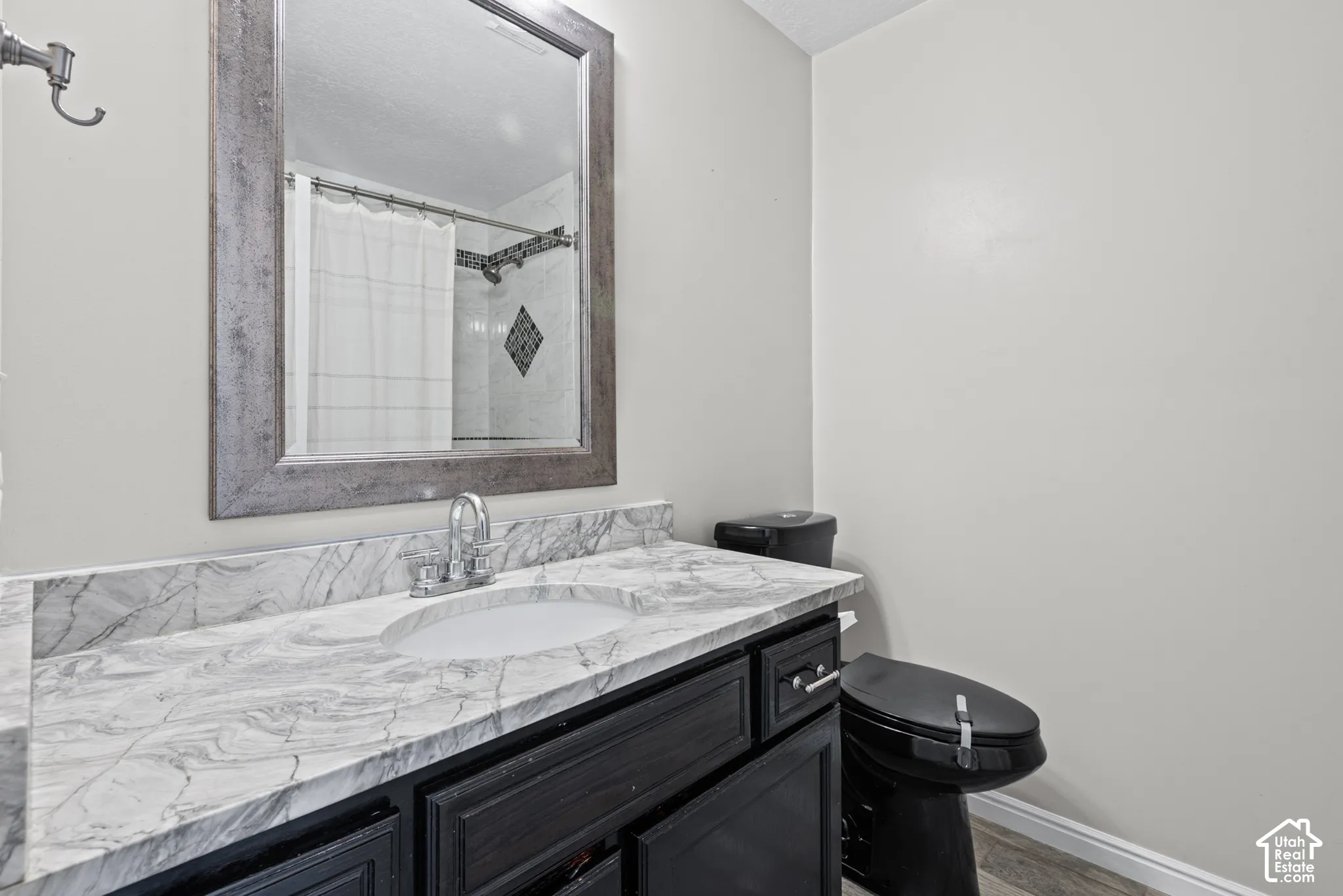 White and gray marble-patterned countertop with an integrated sink