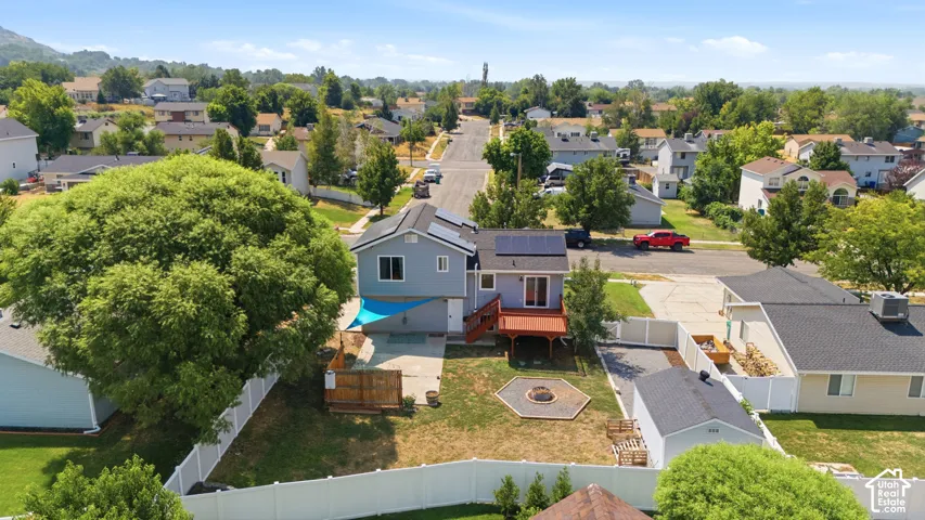 Two-story residence with a multi-level deck, ground-level patio, and a built-in fire pit