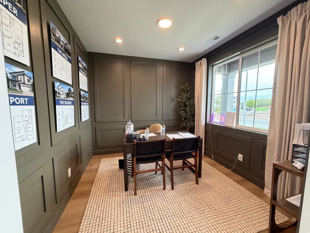 Room featuring dark paneled walls, recessed lighting, and a large multi-pane window