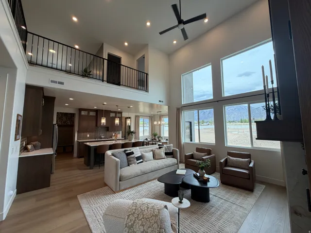 Soaring ceilings and expansive windows frame mountain scenery in this open-concept living space