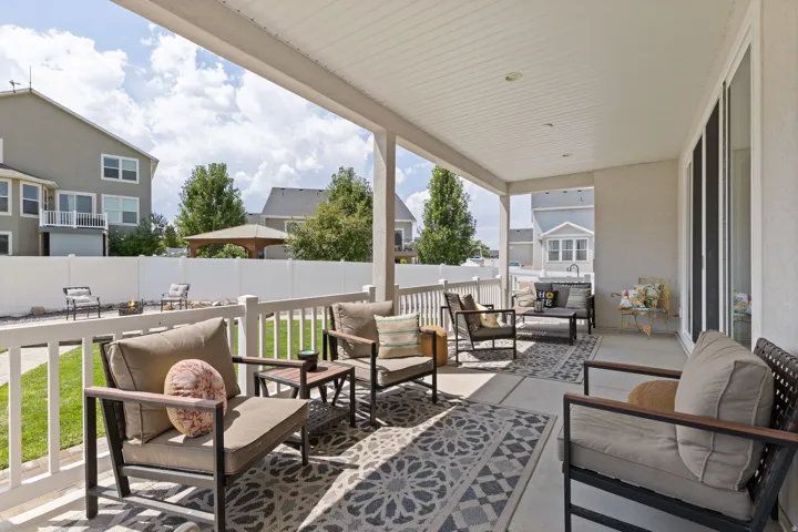Covered patio featuring a solid ceiling with recessed lighting, concrete flooring, and a white railing