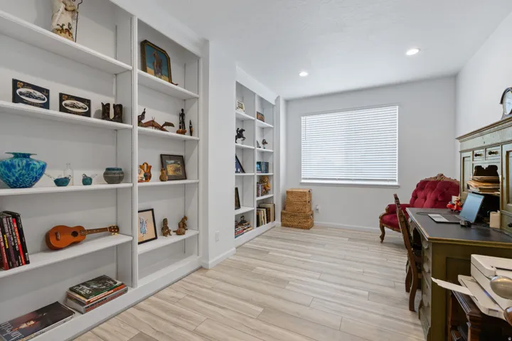Light wood-finish flooring complements abundant built-in shelving