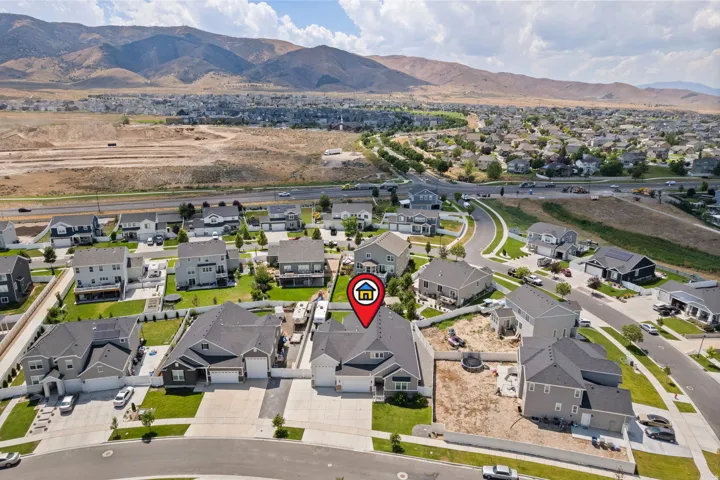 Aerial perspective showcasing the residential neighborhood with mountain backdrops