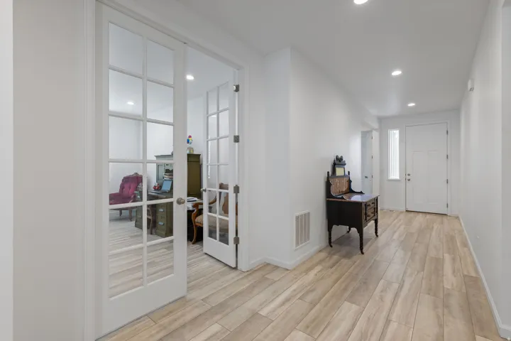 Entryway featuring light wood-finish flooring, recessed lighting, and white walls