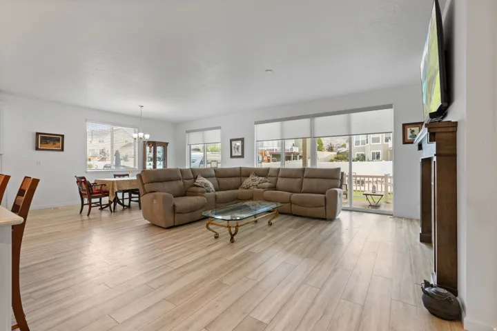 Open-concept living area with light wood-finish flooring