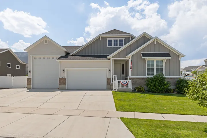 Contemporary exterior with mixed siding, featuring a three-car garage
