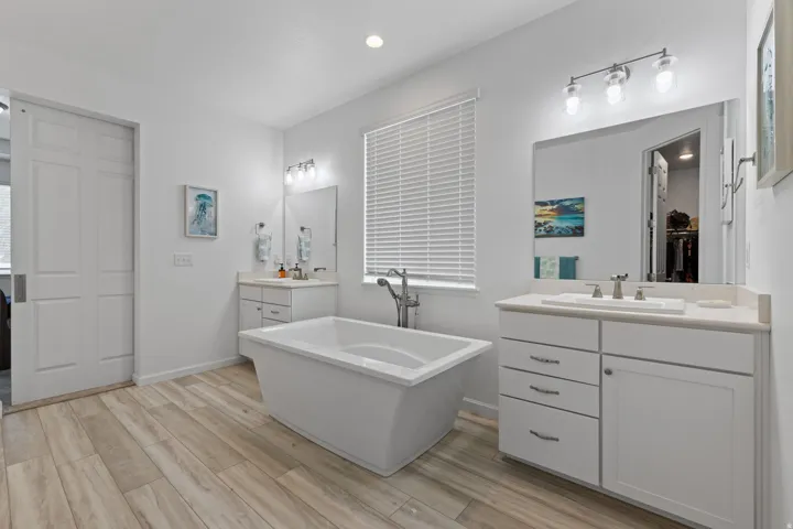 Freestanding soaking tub with brushed nickel fixtures