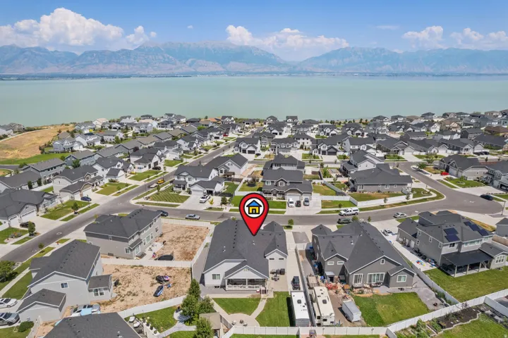 Aerial perspective showcasing a residential area with a prominent body of water and distant mountains