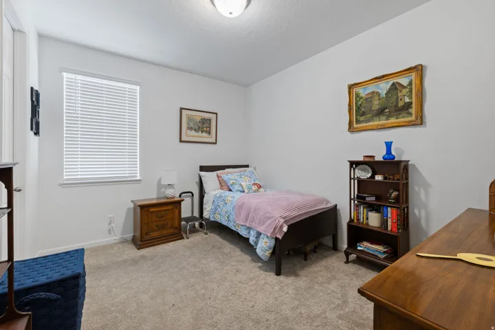 Neutral gray walls complement the light-colored carpet flooring