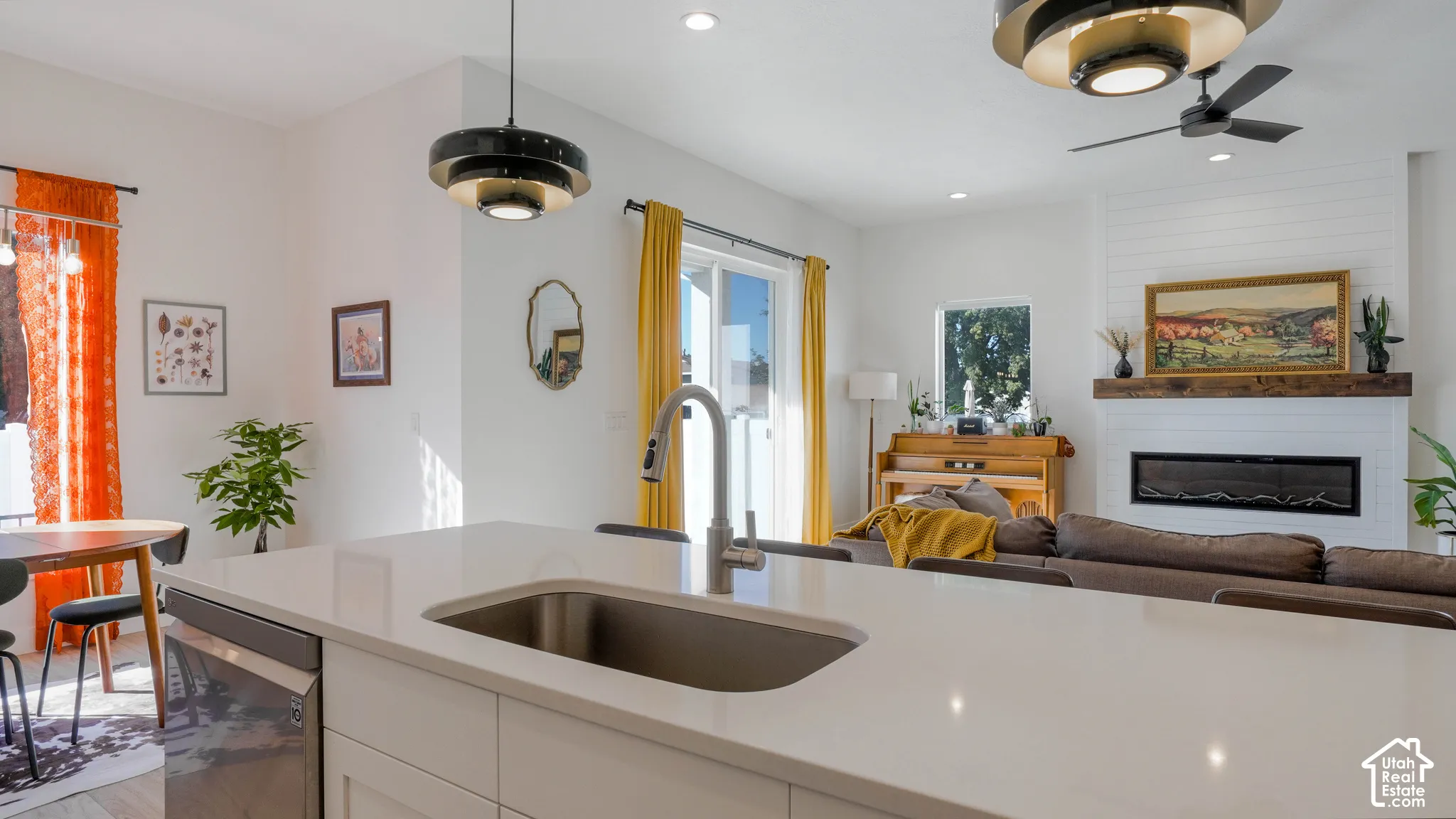 Kitchen island with an undermount stainless steel sink and a gooseneck faucet