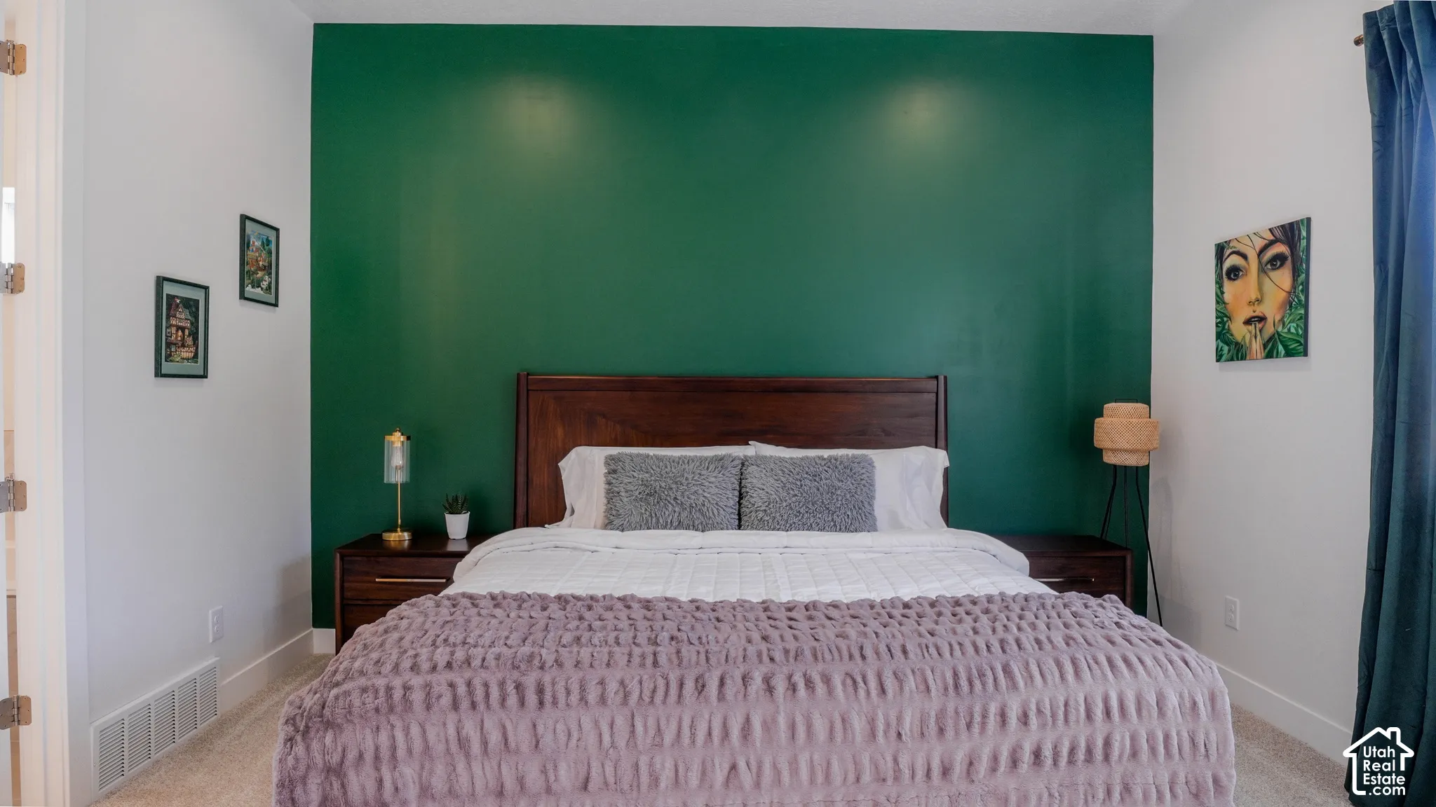 Bedroom featuring an accent wall in a deep green hue, contrasting with white painted walls