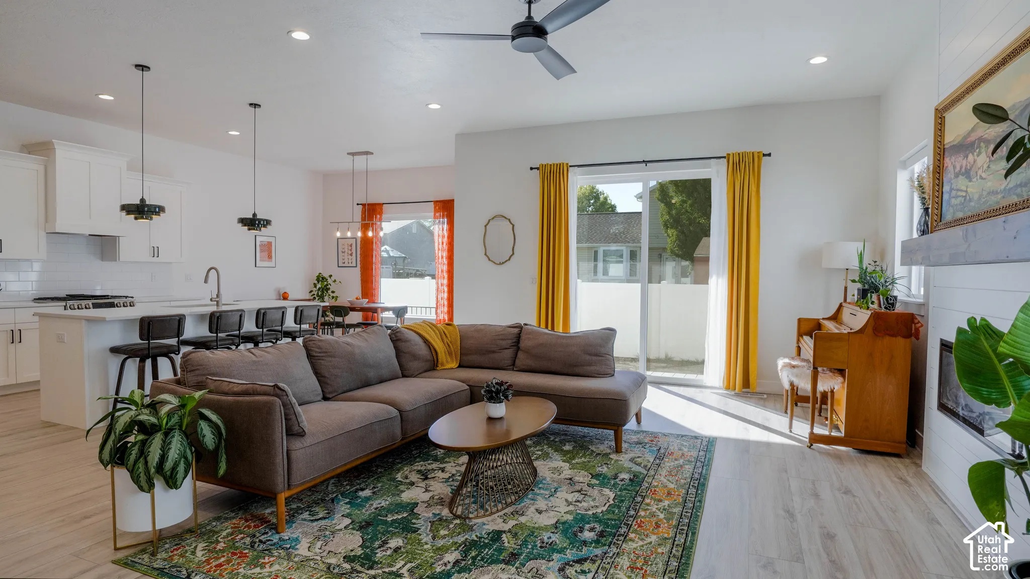 Open-concept living space featuring wood-finish flooring, recessed lighting, and a ceiling fan