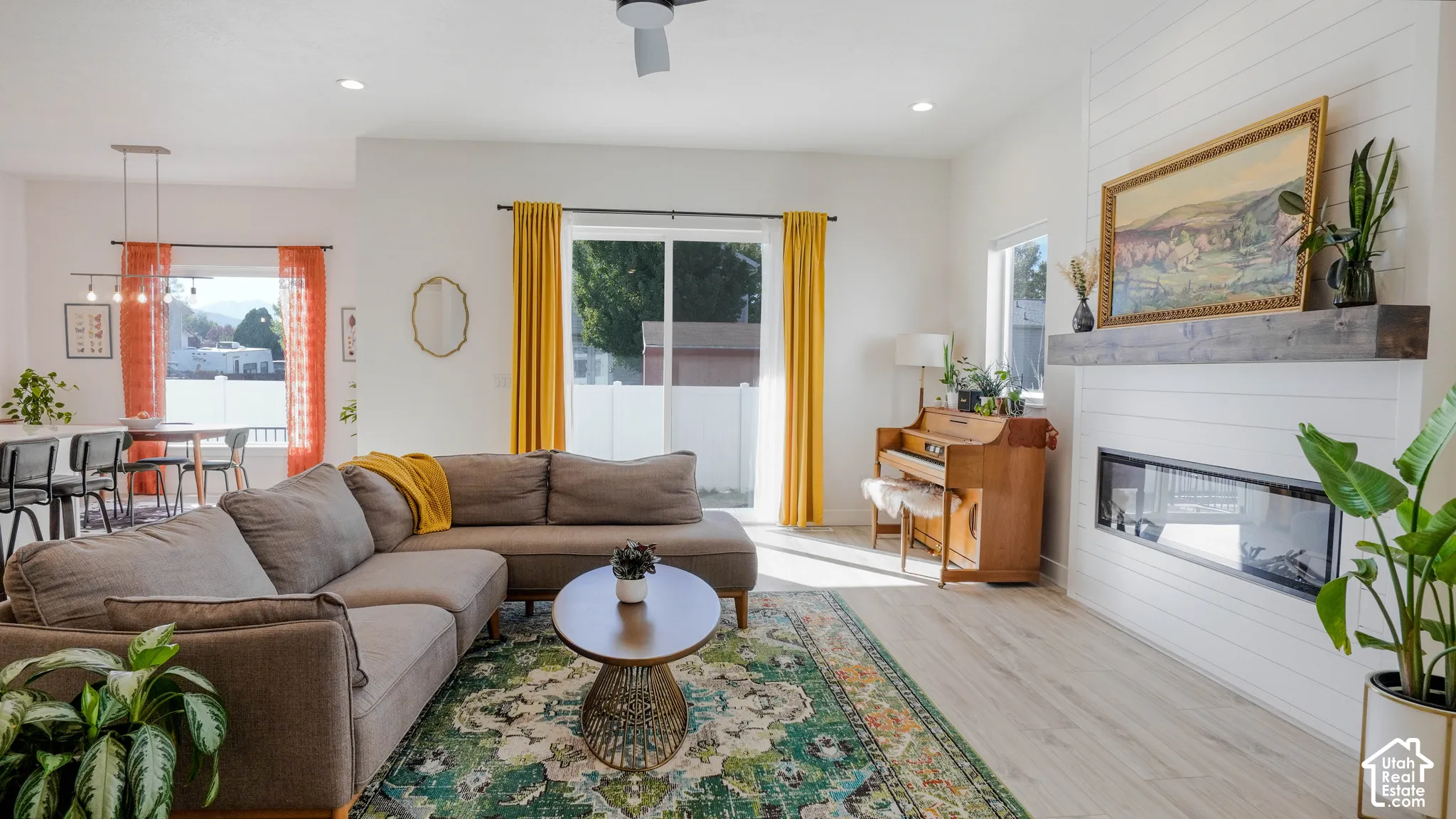 Open-concept living area with light wood-finish flooring