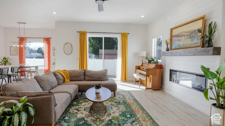 Open-concept living area with light wood-finish flooring