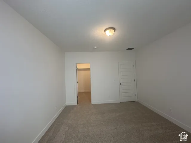 Neutral-toned carpet flooring complementing bright white walls