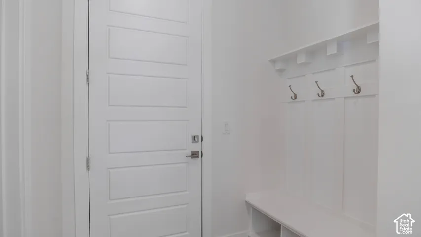 Built-in entryway bench with storage cubbies and wall-mounted coat hooks