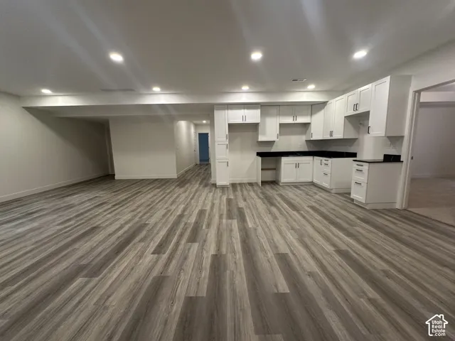 Open-concept room featuring wide plank wood-finish flooring and recessed lighting