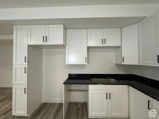Modern kitchen with white shaker-style cabinetry and matte black hardware