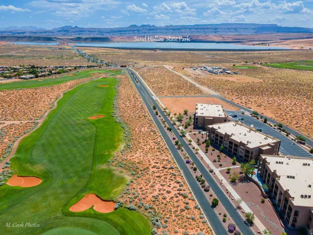 Expansive golf course frontage with manicured green fairways and sand traps