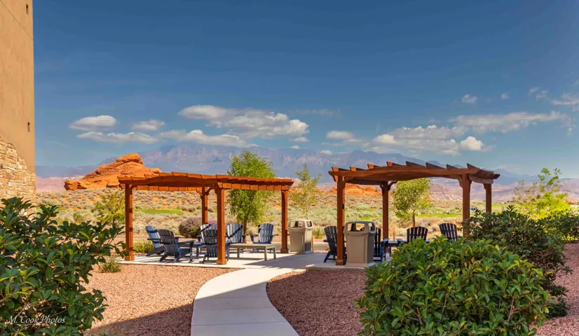 Outdoor patio areas featuring two wooden pergolas over paved seating arrangements