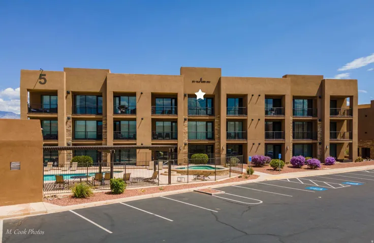 Contemporary multi-story building featuring stucco exterior and multiple private balconies