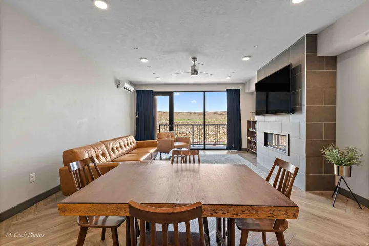 Open-concept living space with wood-finish flooring, recessed lighting, and a ceiling fan