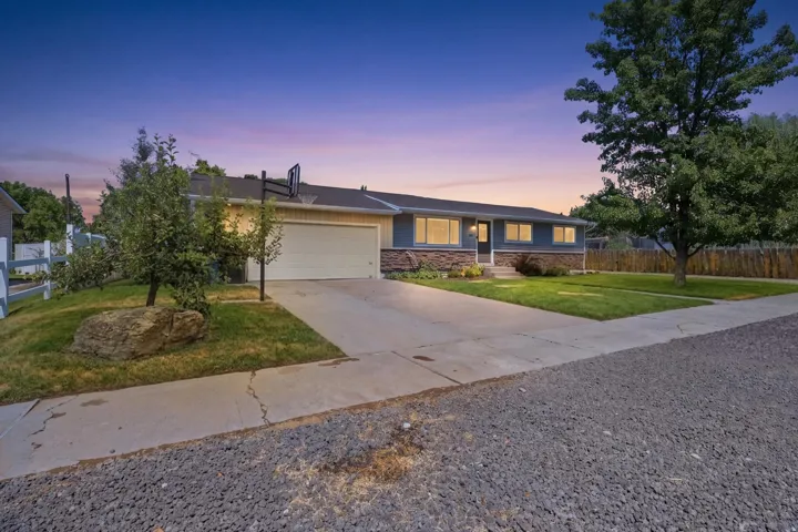 Single-story residence featuring a two-car garage, stone facade accents, and a front entry