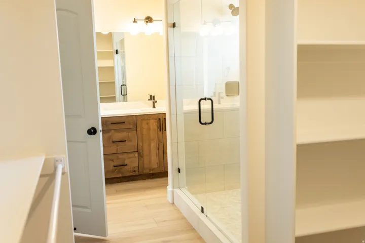 Wood-finish vanity with a white countertop and rectangular sink