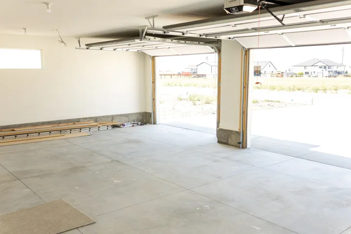 Concrete flooring with white walls and a transom window