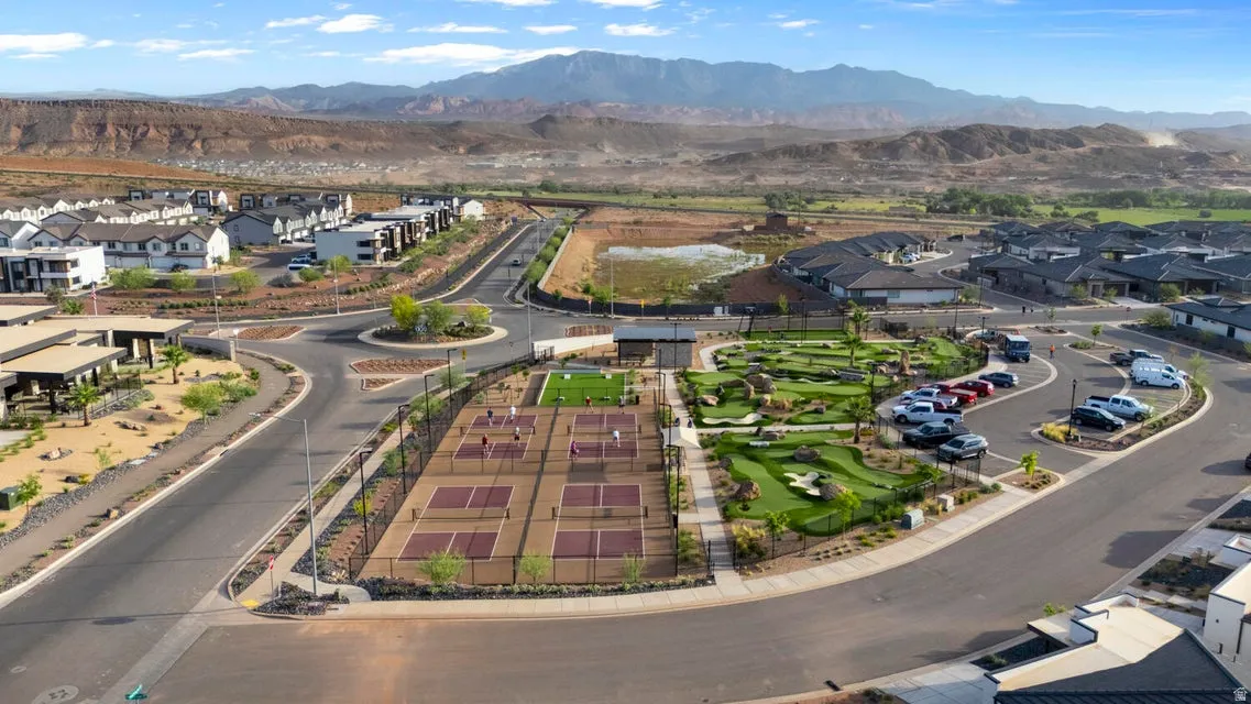 Community amenities featuring multiple pickleball courts, a miniature golf course, and a central roundabout