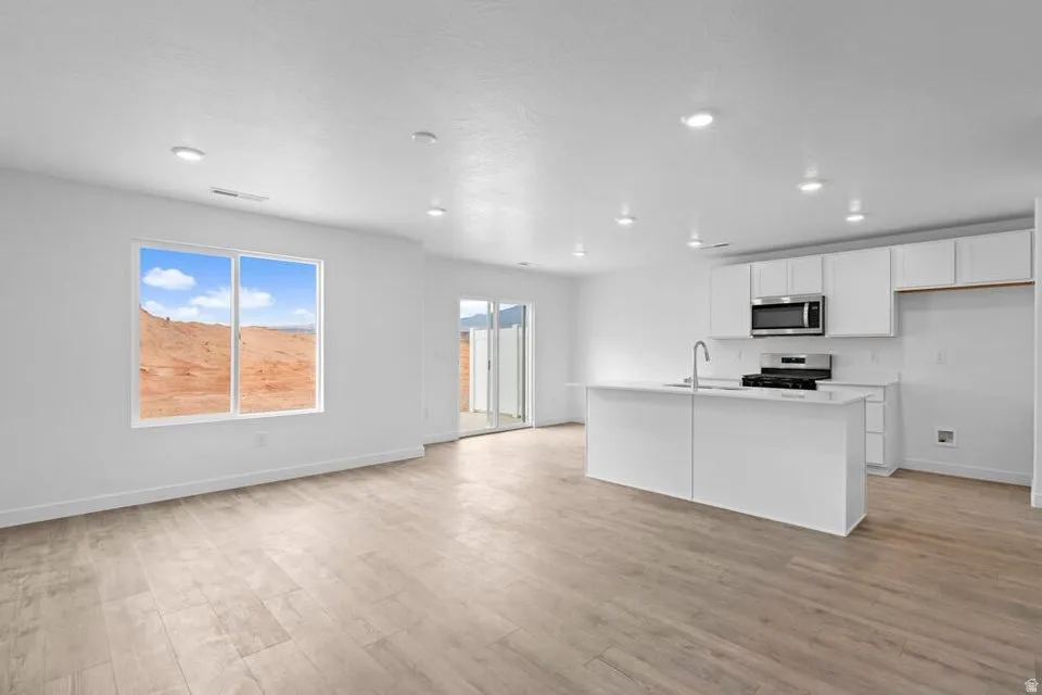 Open concept living space featuring wood-finish flooring