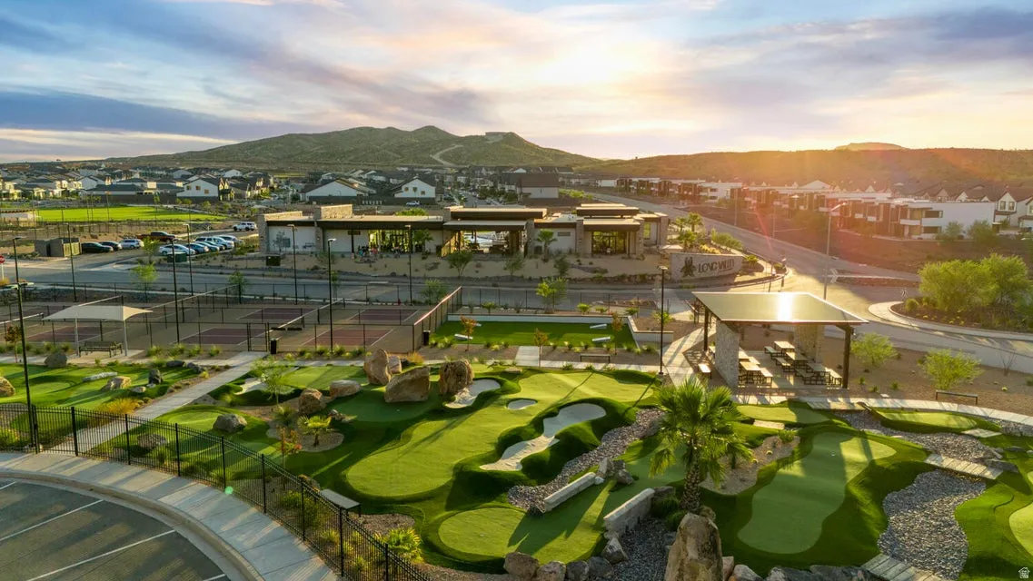 Expansive community amenities featuring a multi-hole putting green, multiple tennis courts, and a covered picnic area