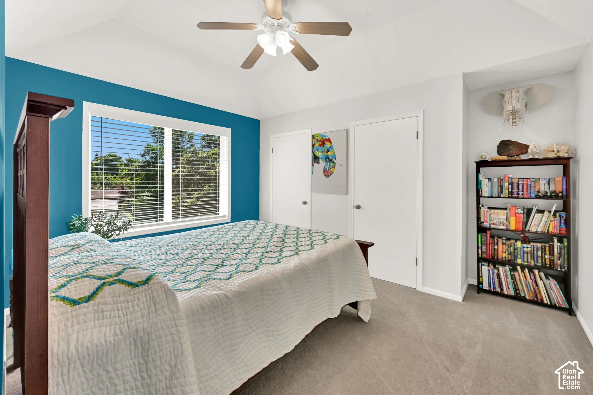Bedroom featuring a vaulted ceiling with a ceiling fan, and a large window