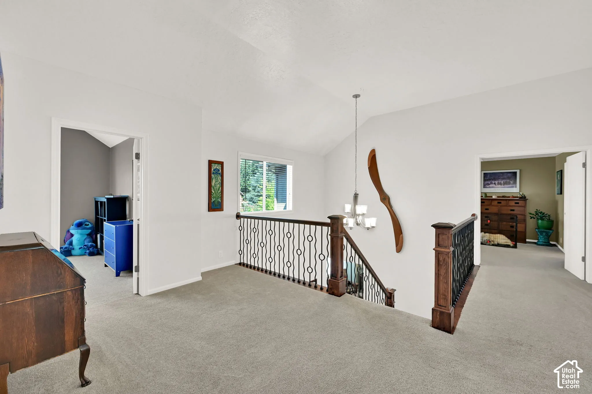 Spacious upper-level landing featuring neutral carpeting, and abundant natural light from multiple windows