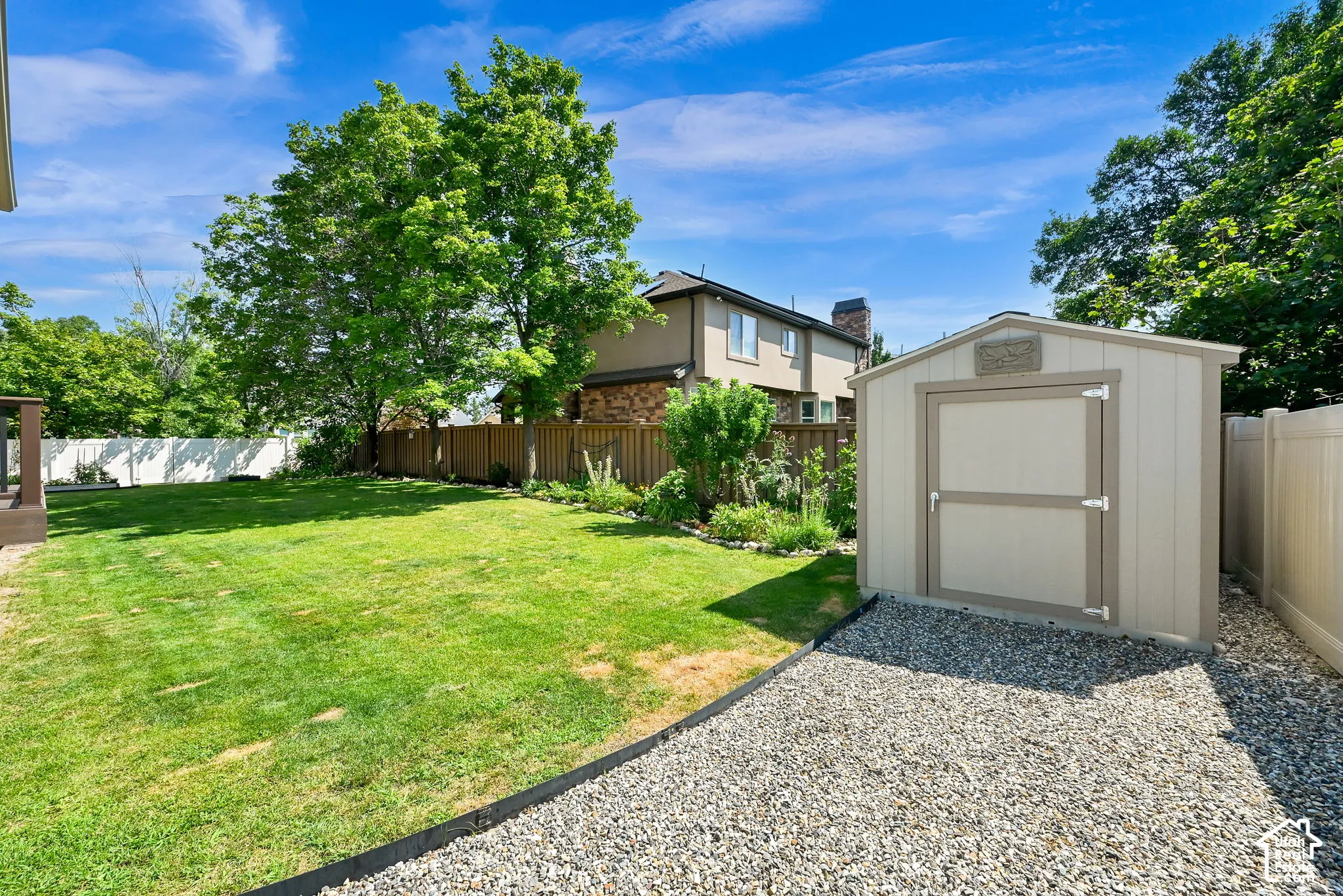Spacious backyard featuring a storage shed