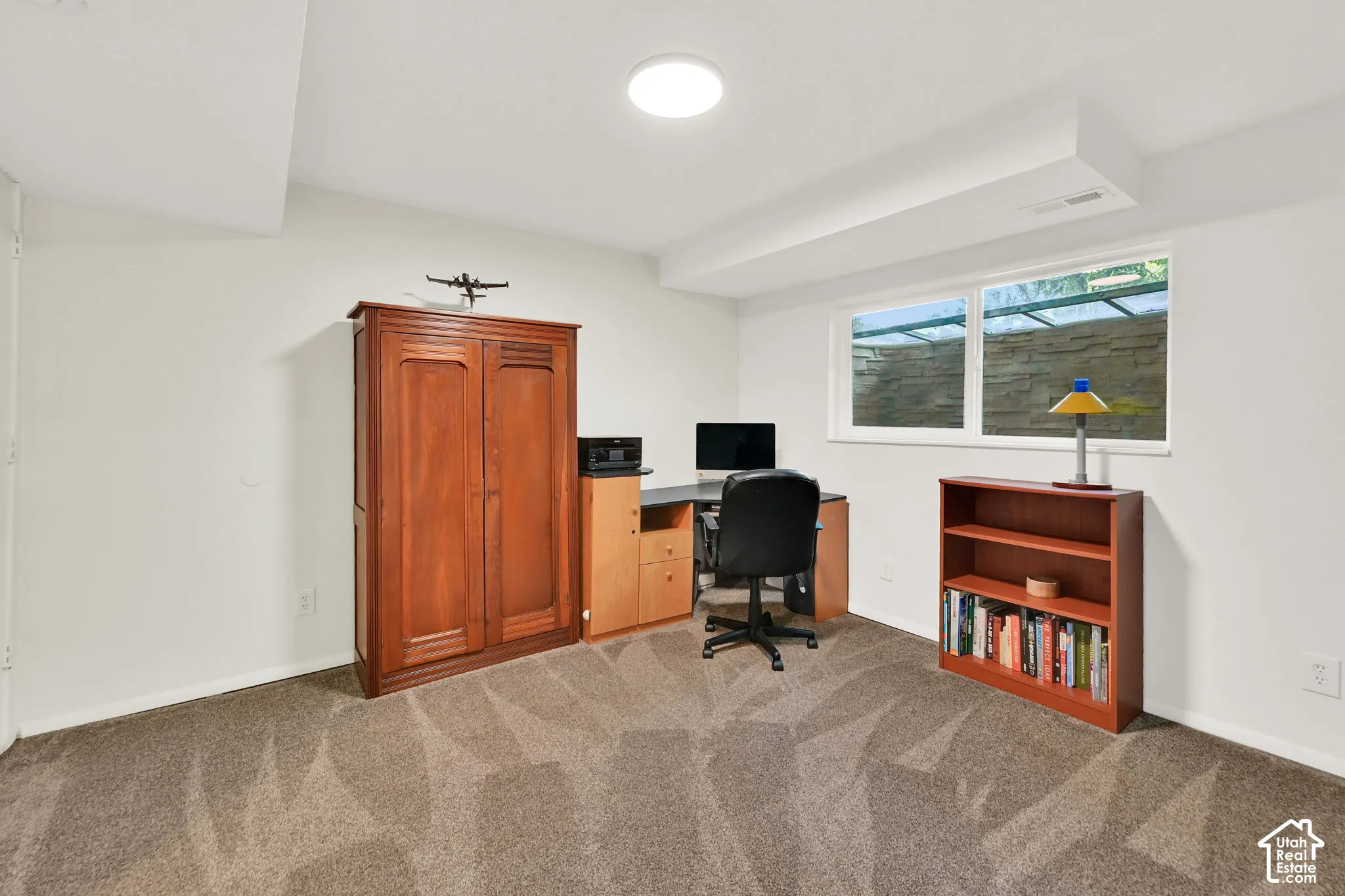 Carpeted room with a recessed window and white trim